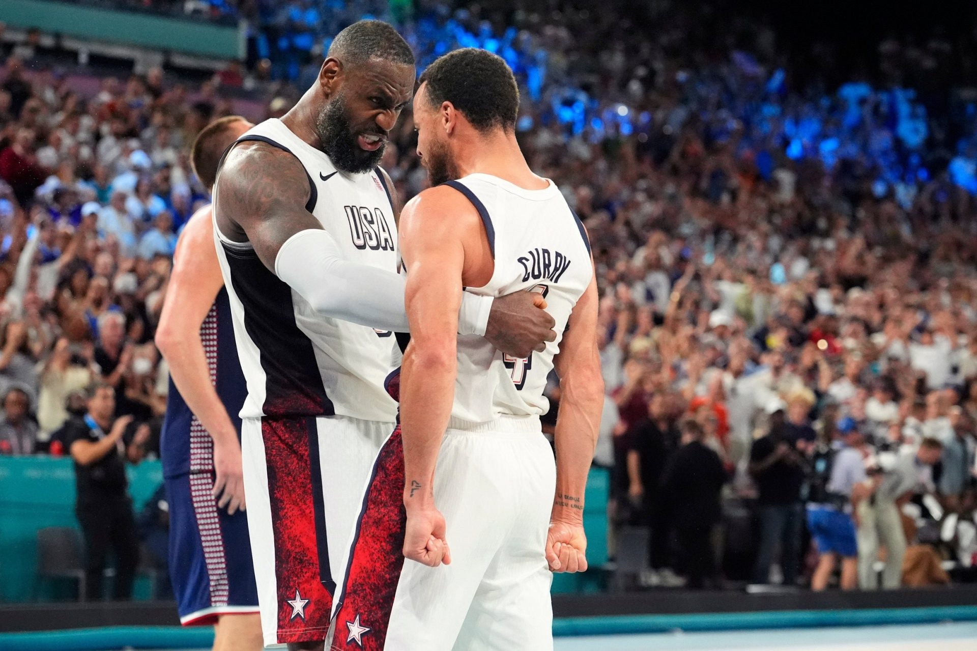 United States forward LeBron James and guard Stephen Curry celebrate after the game against Serbia in a men's basketball semifinal during the Paris 2024 Olympic Summer Games at Accor Arena on Aug. 8, 2024. Credit: Imagn