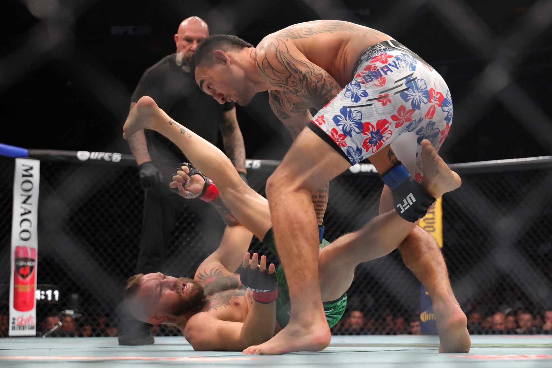 Conor McGregor (red gloves) fights Max Holloway (blue gloves) in a welterweight bout during UFC 329 at T-Mobile Arena.