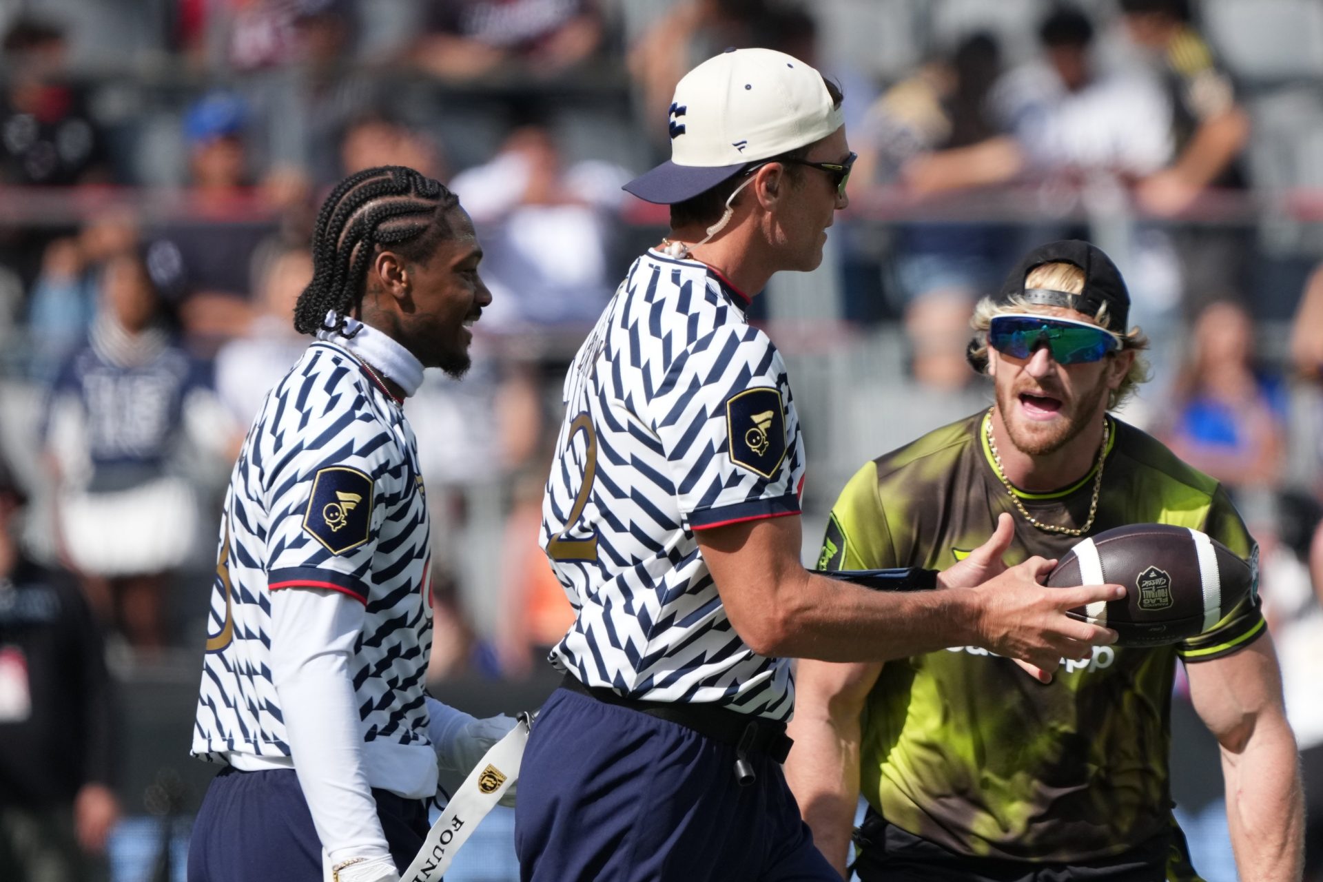 Founders FFC receiver Stefon Diggs (left) and quarterback Tom Brady (center) interact with Logan Paul of Wildcats FFC during the Fanatics Flag Football Classic at BMO stadium.