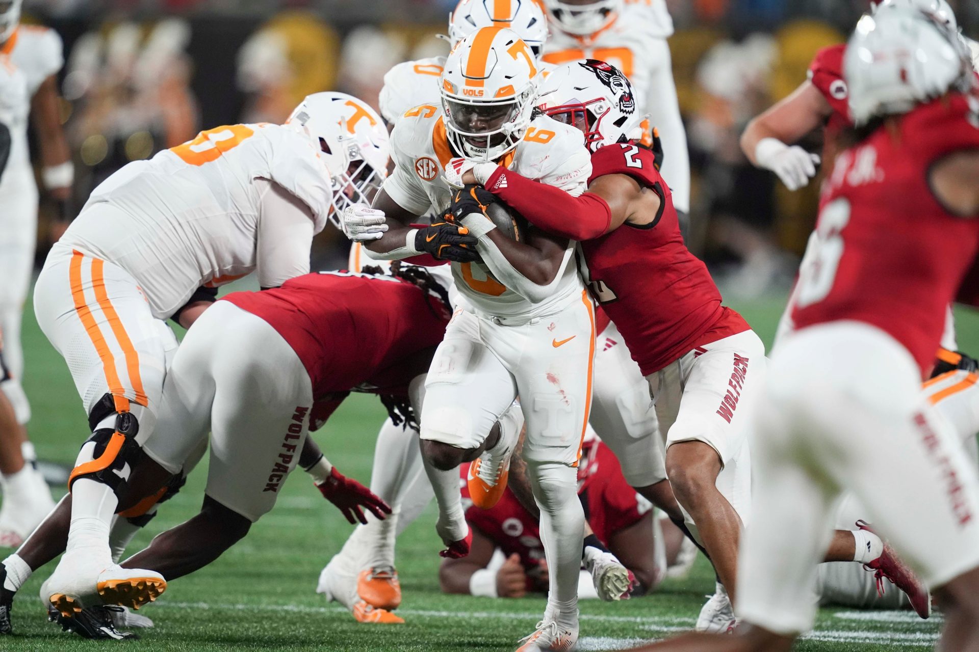 Tennessee running back Dylan Sampson (6) runs the ball while tackled by N.C. State cornerback Brandon Cisse (2) at the NCAA College football game between Tennessee and NC State on Saturday, Sept. 7, 2024 in Charlotte, NC. Credit: Imagn