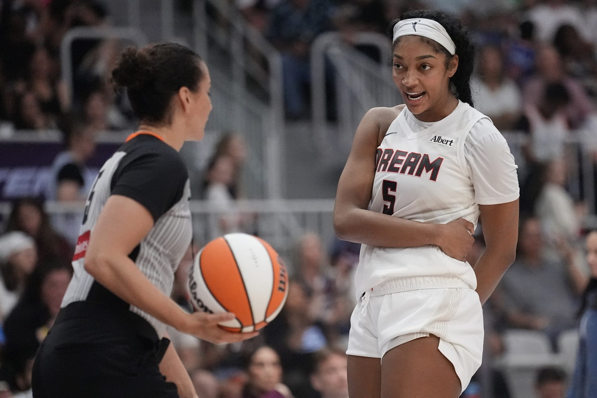 Atlanta Dream forward Angel Reese (5) talks with game official Tiara Cruse after a play against the Toronto Tempo during the second half at Coca-Cola Coliseum.