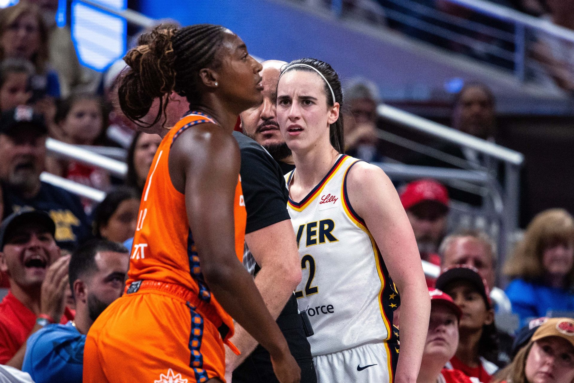 Connecticut Sun forward Diamond Miller (1) gets a technical foul for after whistle contact on Indiana Fever guard Caitlin Clark (22) in the second half at Gainbridge Fieldhouse.
