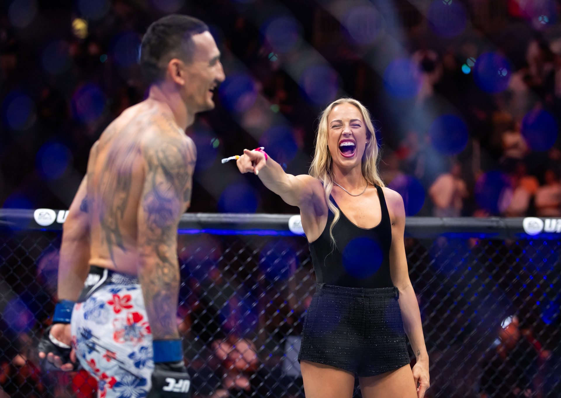 Indiana Fever guard Sophie Cunningham (right) laughs as she points at Max Holloway following UFC 329 at T-Mobile Arena.