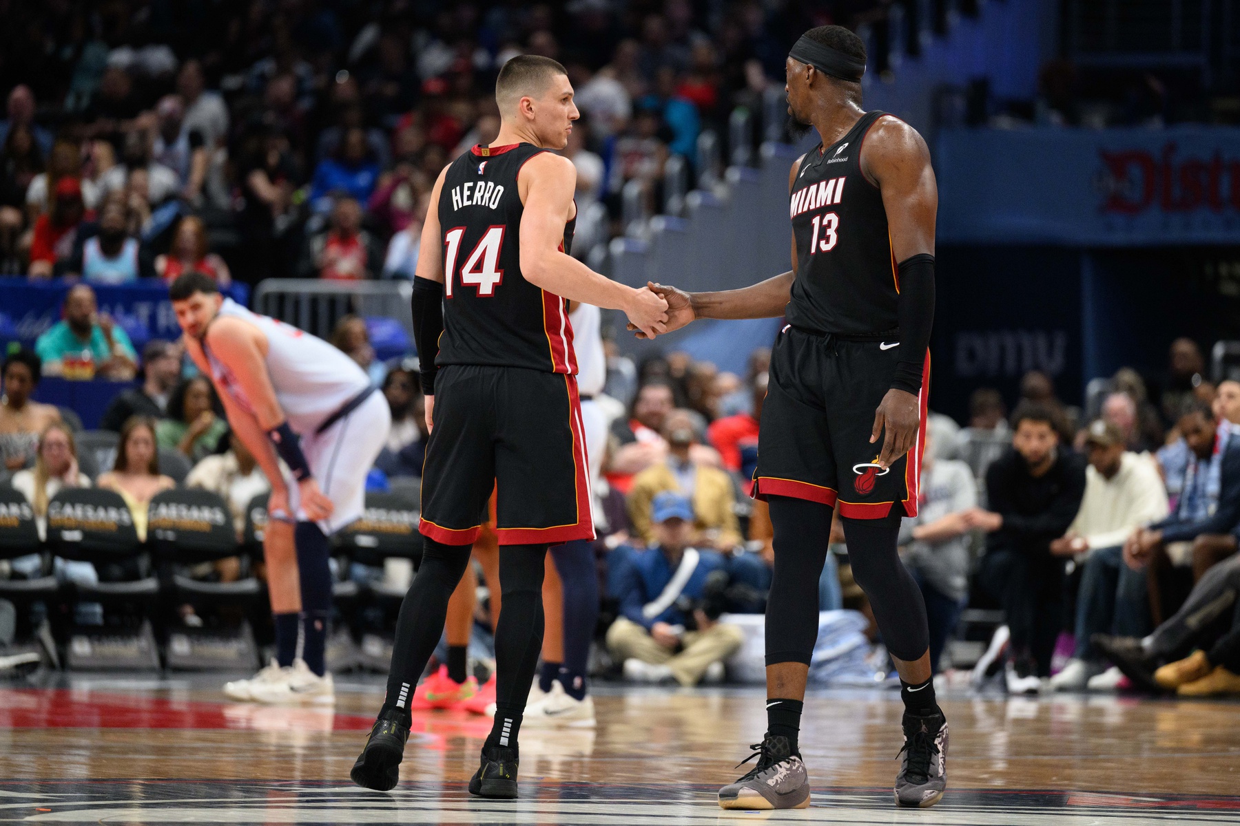Miami Heat guard Tyler Herro (14) and center Bam Adebayo (13) react during the third quarter against the Washington Wizards - Source: Imagn Images