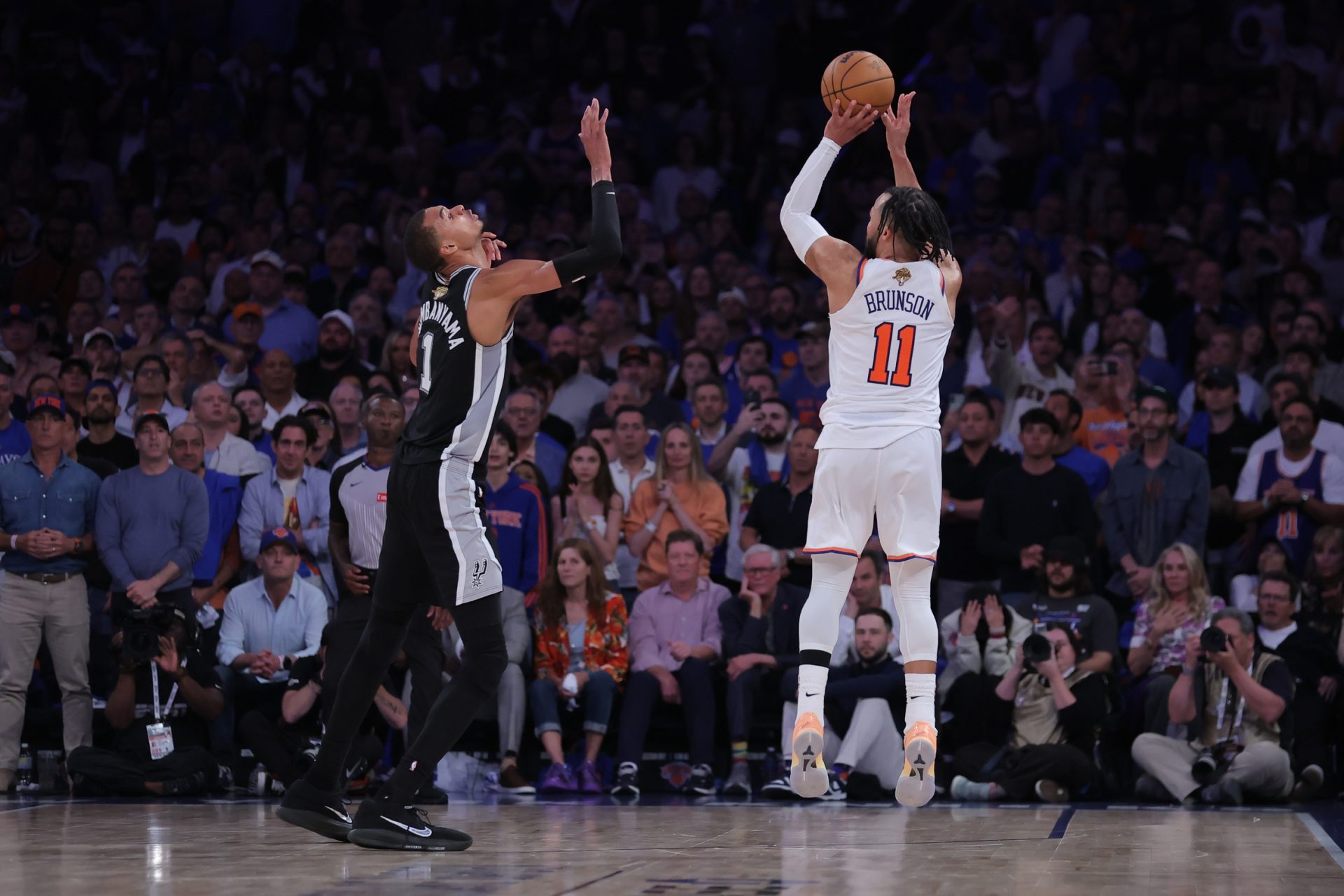 New York Knicks guard Jalen Brunson (11) shoots against San Antonio Spurs forward Victor Wembanyama (1) in the fourth quarter during game four of the 2026 NBA Finals - Source: Imagn Images