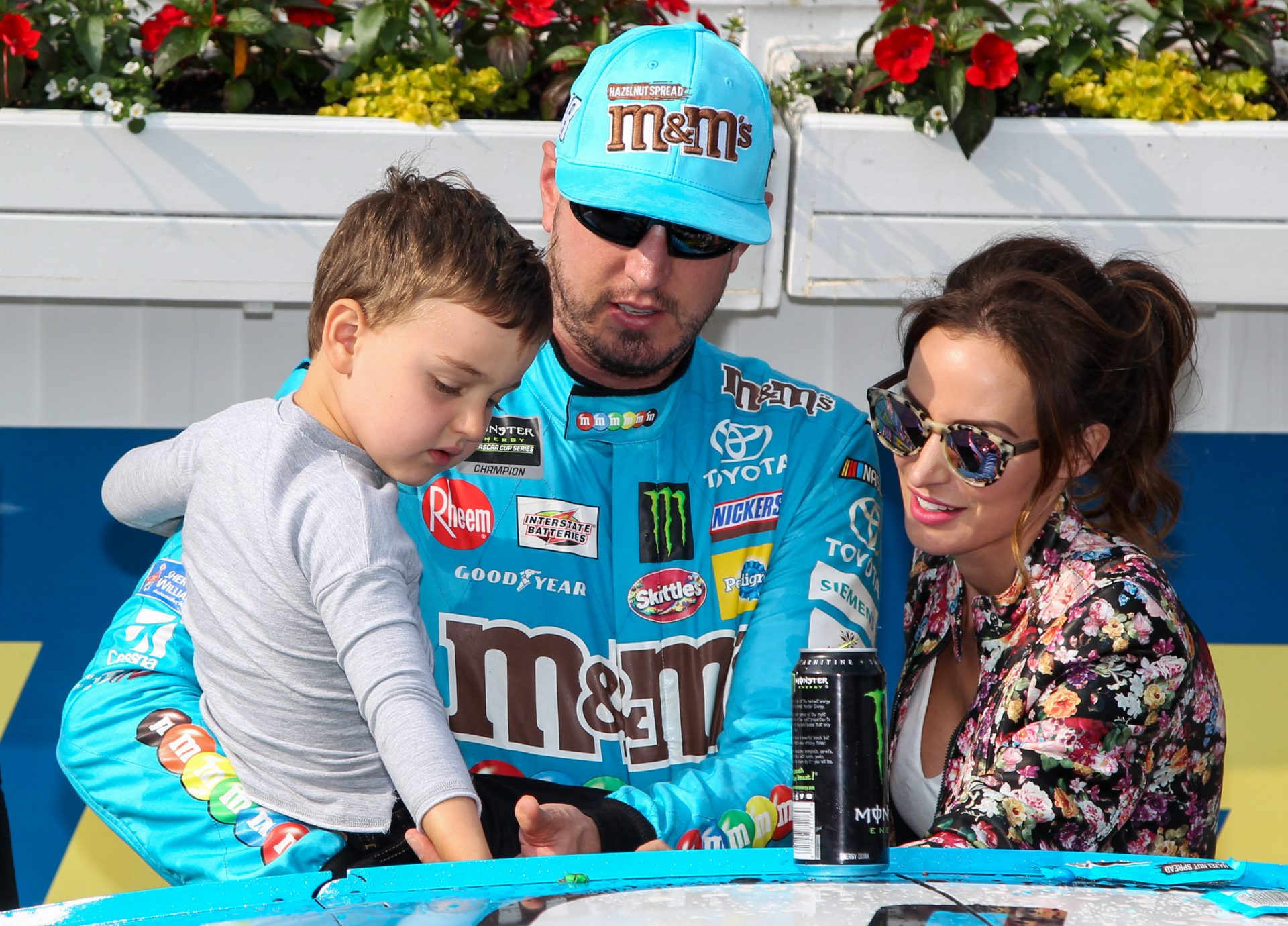 NASCAR Cup Series driver Kyle Busch helps his son Brexton Busch apply the winners sticker to his car after winning the Pocono 400 at Pocono Raceway.