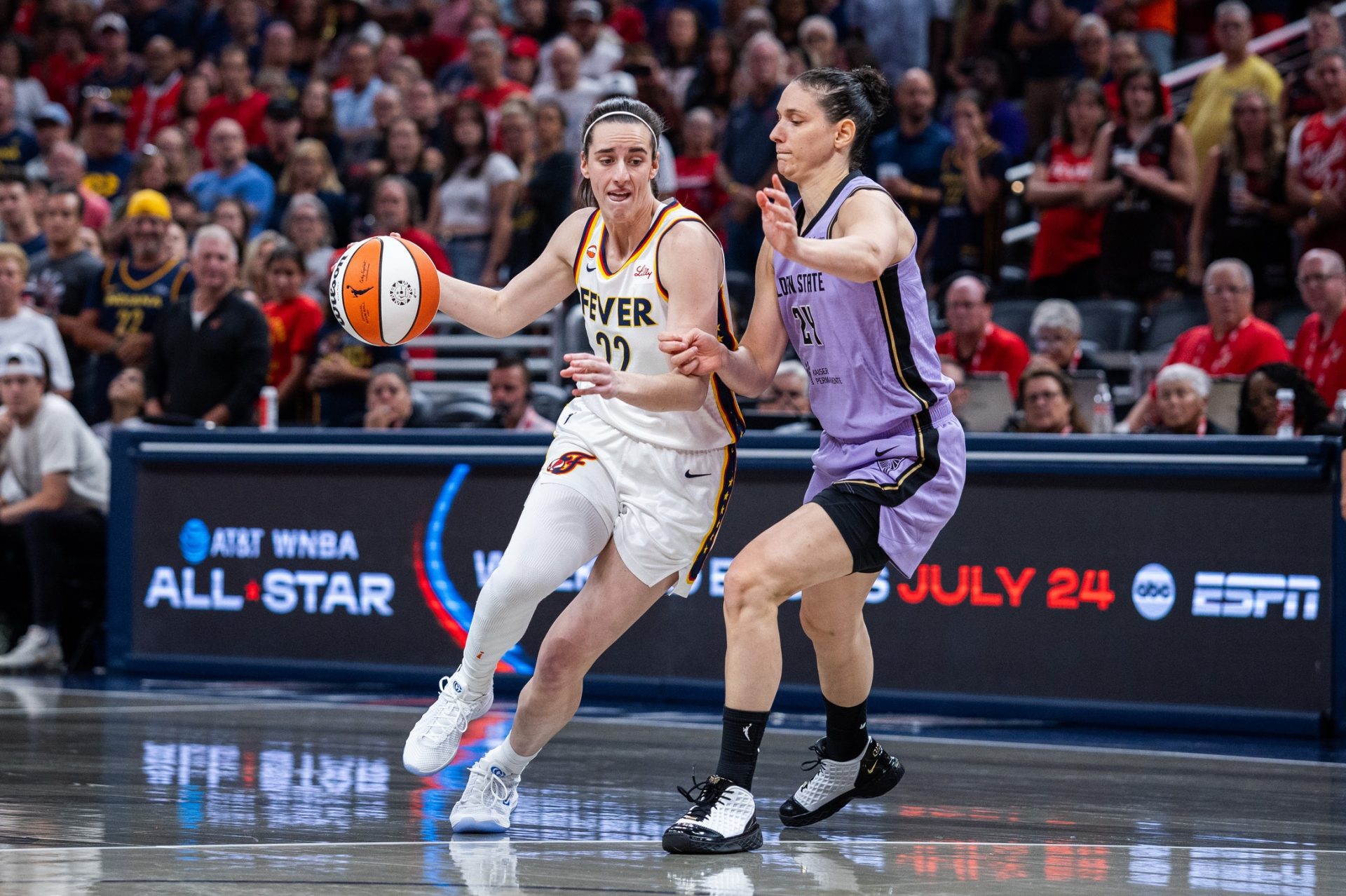 Indiana Fever guard Caitlin Clark (22) dribbles the ball while Golden State Valkyries forward Cecilia Zandalasini (24) defends in the first half  - Source: Imagn Images