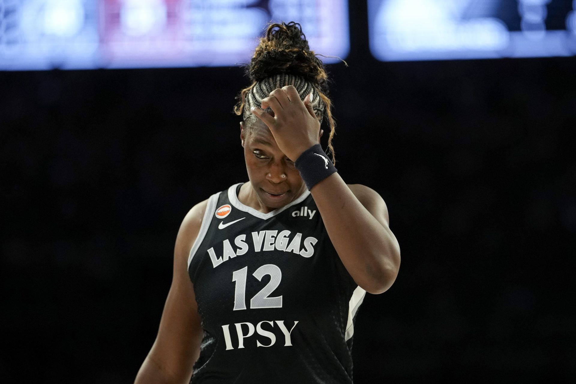 Las Vegas Aces guard Chelsea Gray (12) holds her head during the second quarter of a WNBA basketball game.