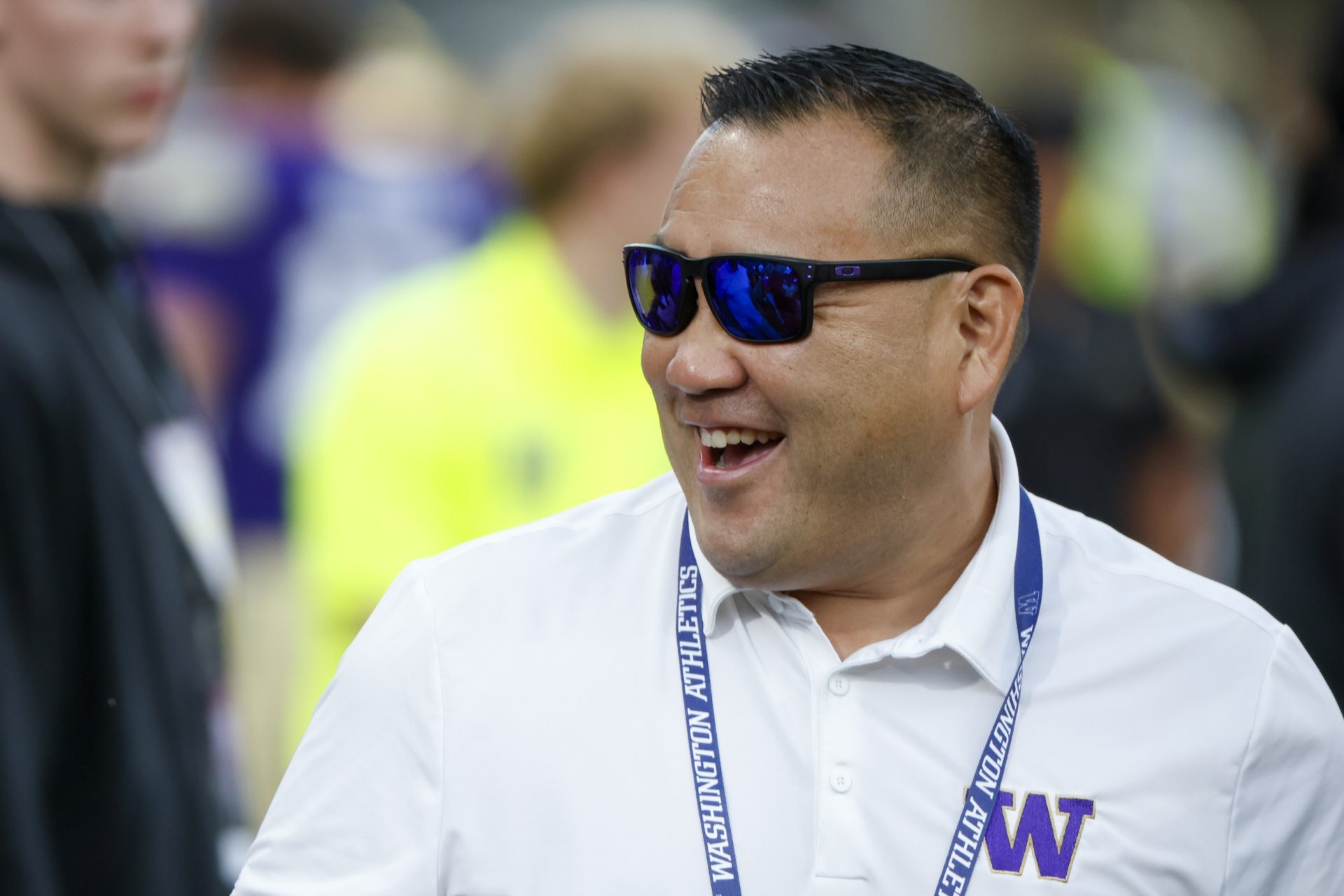 Washington Huskies Athletic Director Pat Chun talks on the sideline during pregame warmups against the Colorado State Rams at Husky Stadium.