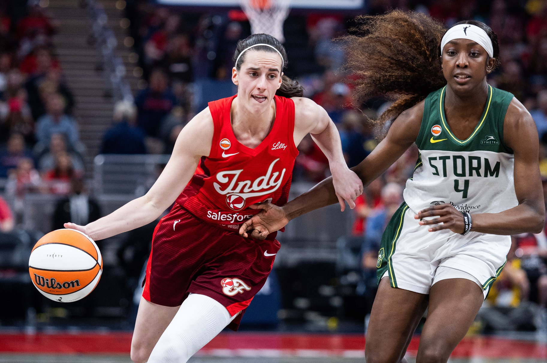 Indiana Fever guard Caitlin Clark (22) dribbles the ball against Seattle Storm guard Flau'jae Johnson (4) in the second half at Gainbridge Fieldhouse. Source: Imagn