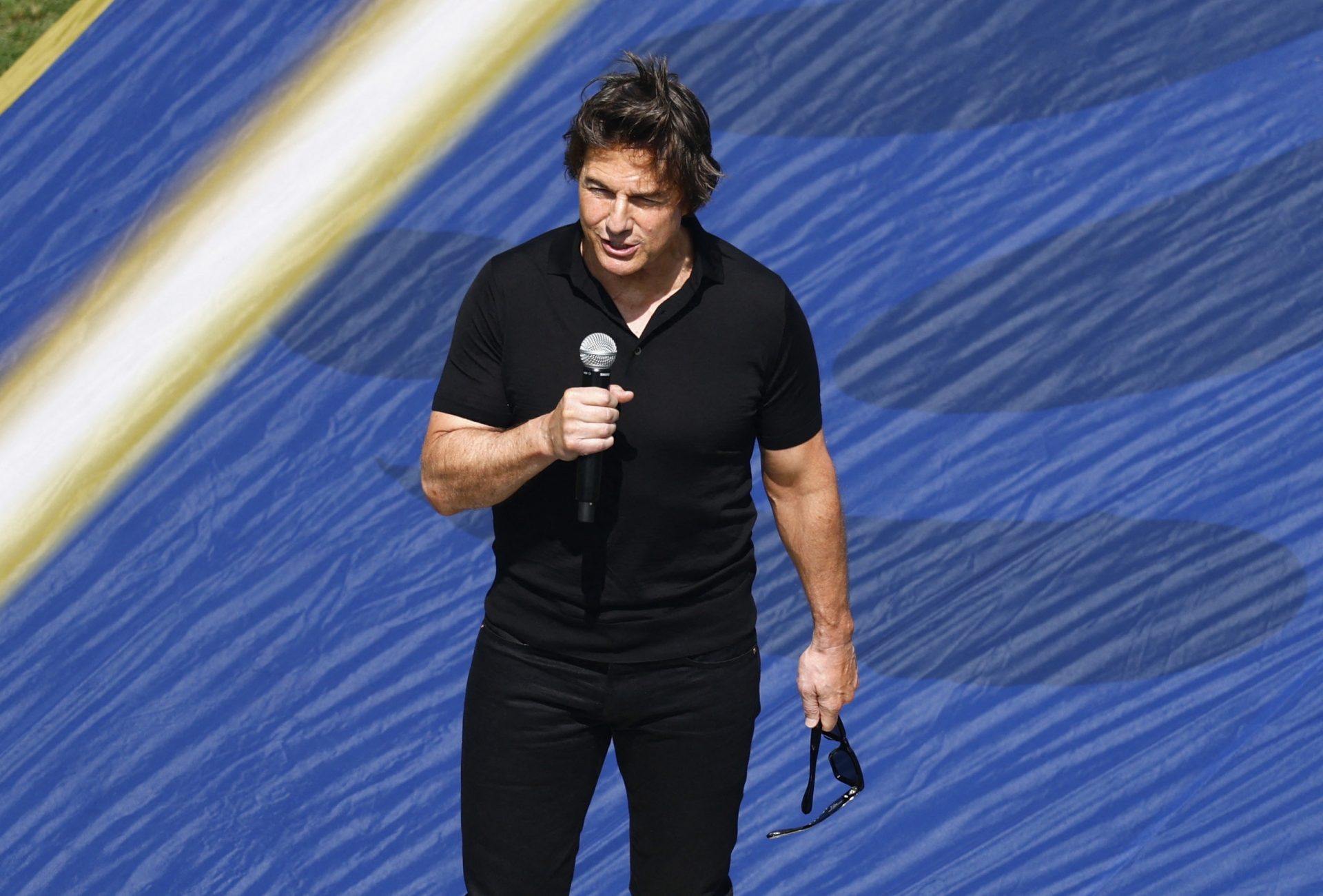 Actor Tom Cruise speaks during the closing ceremony before the match.