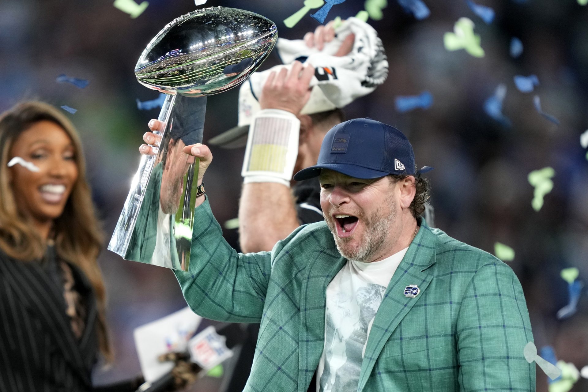 Seattle Seahawks general manager John Schneider celebrates with the Vince Lombardi trophy on the podium after defeating the New England Patriots in Super Bowl LX at Levi's Stadium. 
Source: Imagn