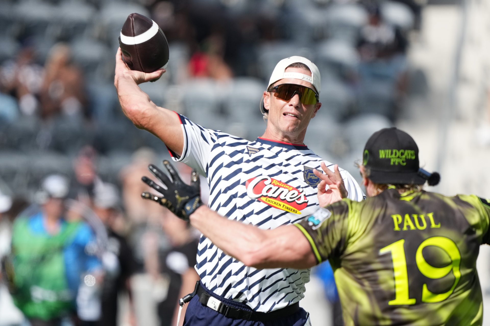 Founders FFC quarterback Tom Brady (12) throws ball against Logan Paul of Wildcats FFC during the Fanatics Flag Football Classic at BMO stadium. Source: Imagn