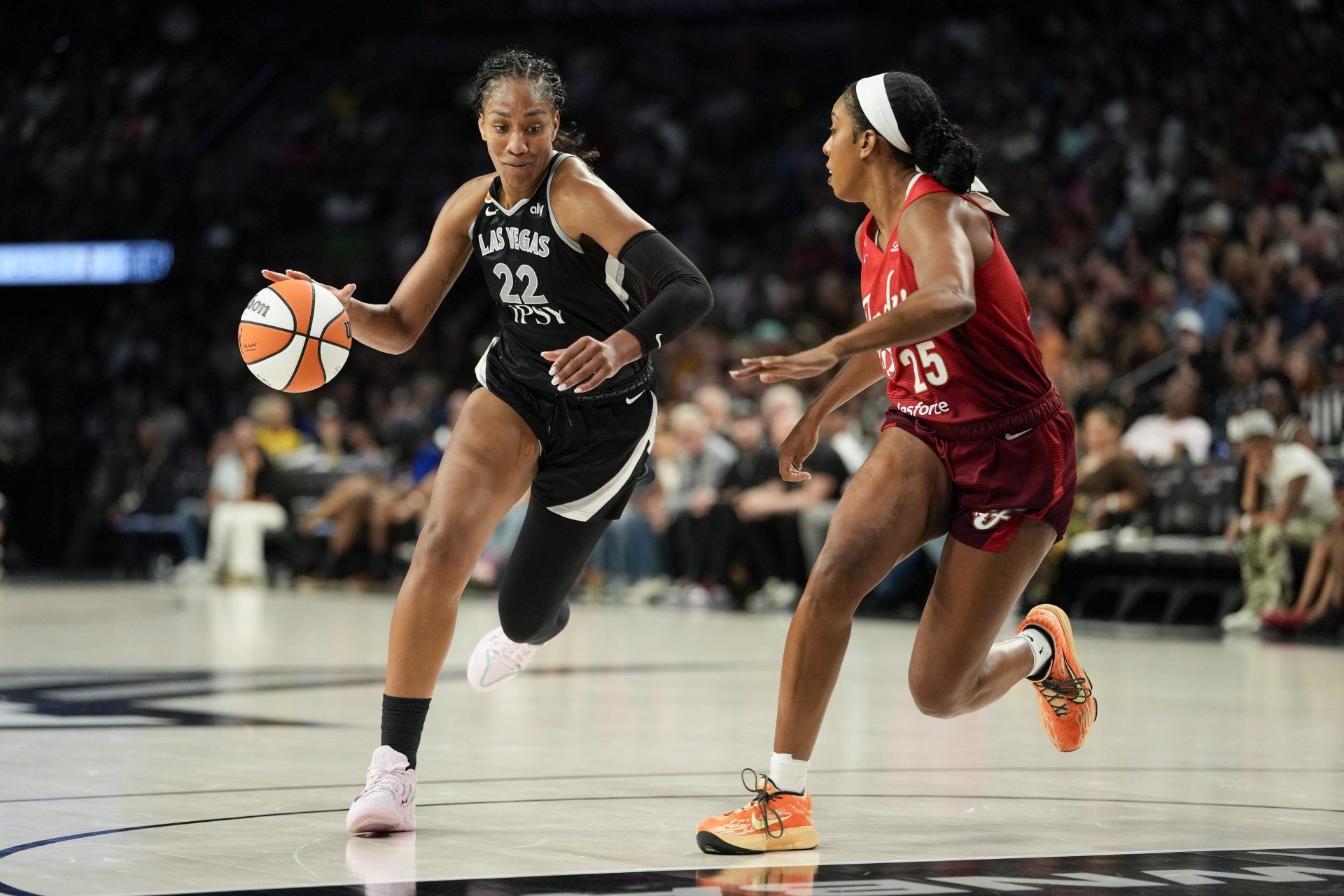 Las Vegas Aces center A'ja Wilson (22) dribbles the ball against Indiana Fever forward Monique Billings (25) during the fourth quarter of a WNBA basketball game at Michelob Ultra Arena. Source: Imagn
